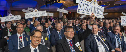 Delegates to the 143rd Supreme Convention raise their jurisdiction signs to confirm their support during the business session.