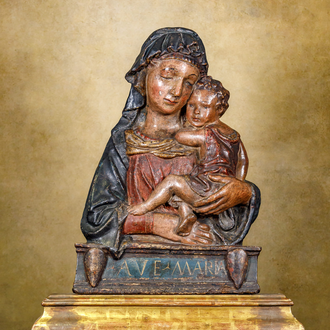 Photo of a painted wood bust of Mary holding the Christ Child in her arms. Below the depiction it reads “AVE MARIA.”