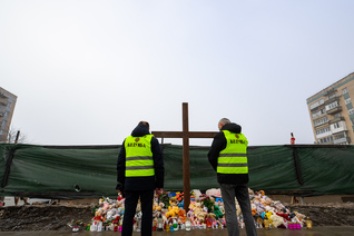 Knights stand near the site of a residential building destroyed in a Russian attack in Ternopil, Ukraine.