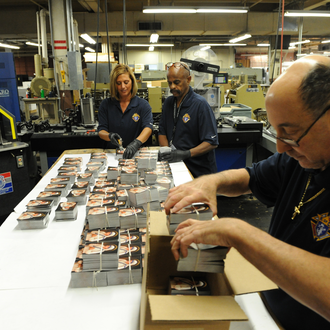 Men and women working in the Knights of Columbus printing plant package and ship out prayer cards for Mother Teresa's canonization