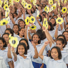 Students wave paper flowers during the Supreme Council delegation’s Aug. 21 visit to Girlstown