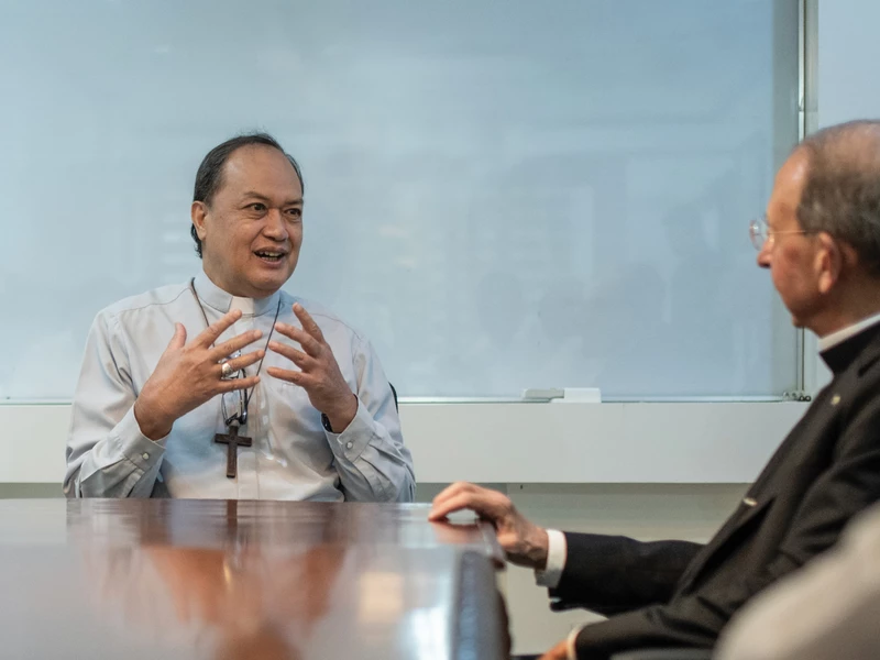 Bishop Pablo David of Kalookan speaks with Archbishop Lori. 