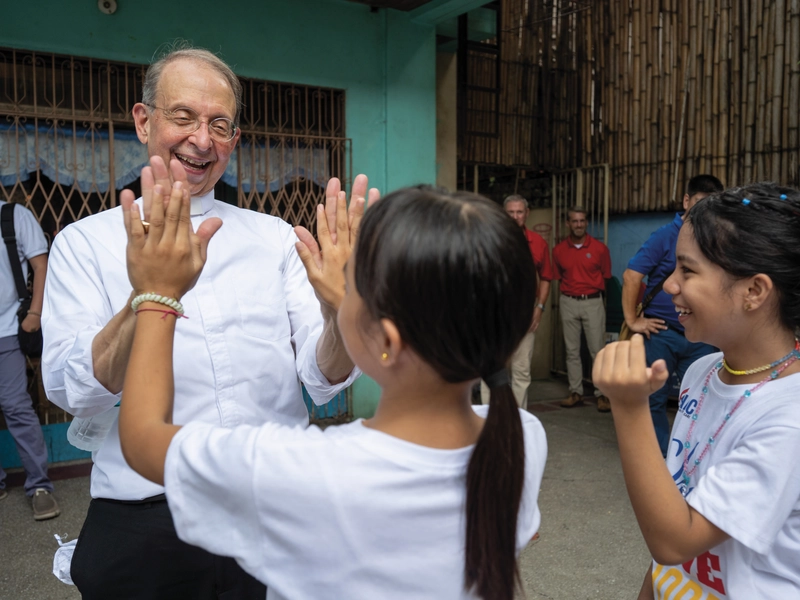 Supreme Chaplain Archbishop William Lori plays a game with children at one of ANAK-Tnk&rsquo;s centers in Metro Manila.