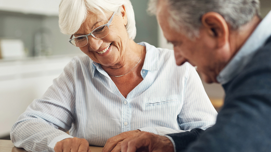 Two people looking at a sheet