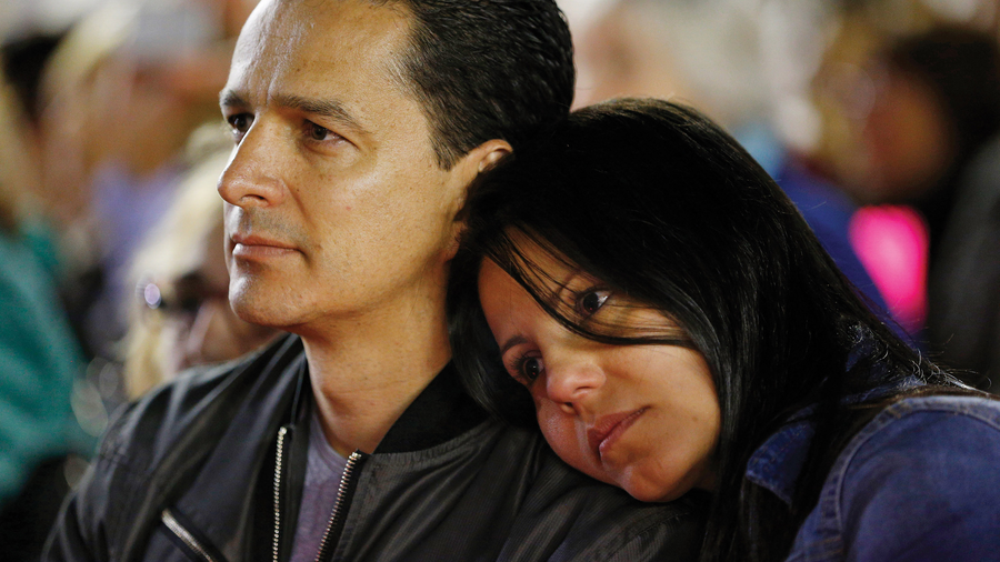 Woman putting head on man's shoulder