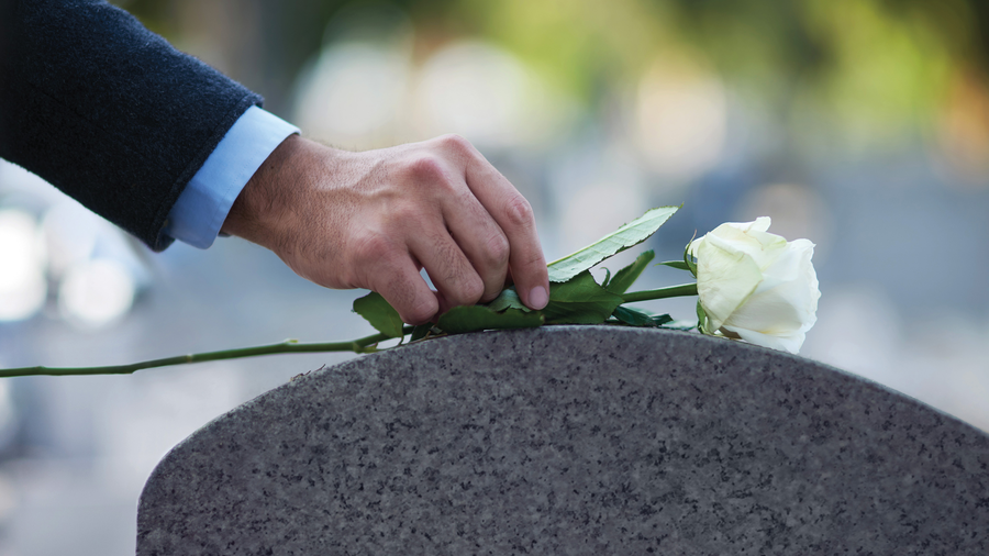 Placing a rose on a stone