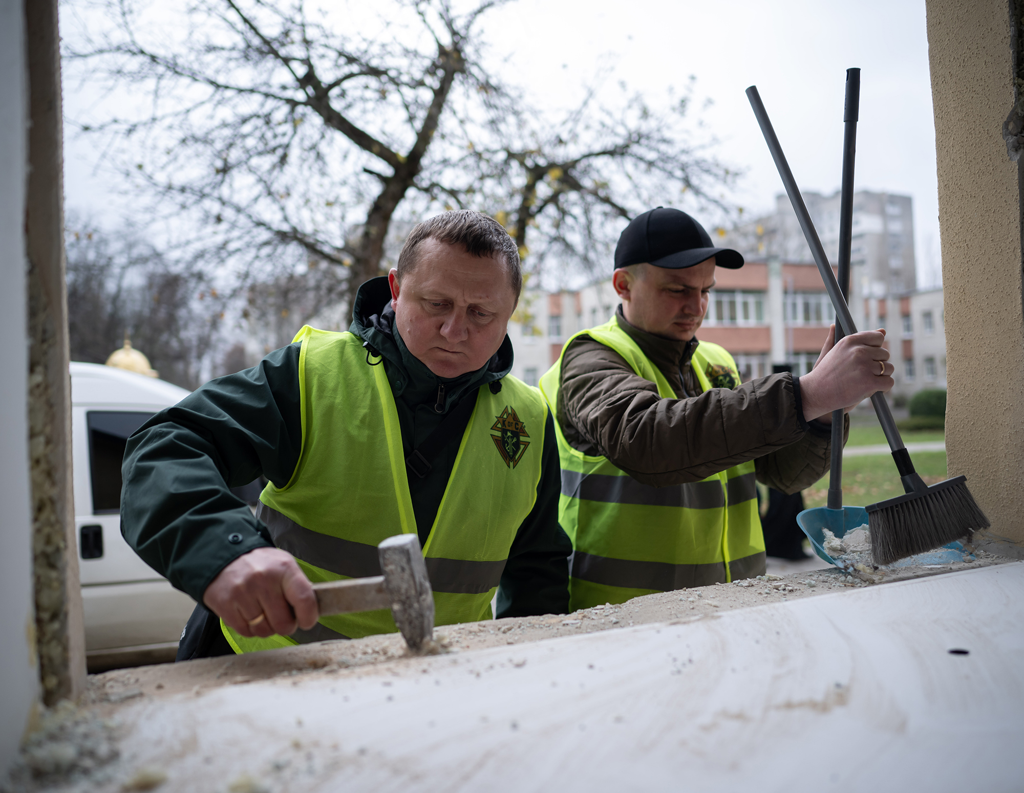 Knights restore a church building damaged by a Russian attack in Lviv.