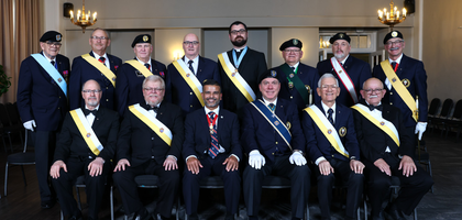Several Knights, some seated and some standing pose together dressed in formal attire and their customary 4th degree Exemplifications.