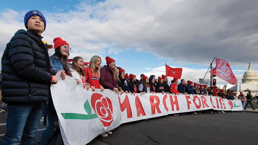 Students from Liberty University in Lynchburg, Va., lead the 50th March for Life past the U.S. Capitol on Jan. 20. • Top right: Jeanne Mancini, president of the March for Life Education and Defense Fund, walks with the crowd of tens of thousands of pro-life advocates toward Capitol Hill.