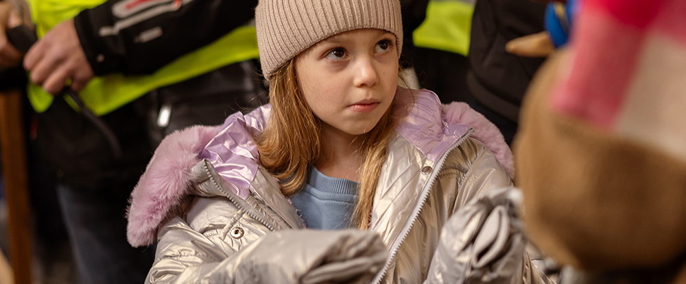 A small child wearing a winter coat