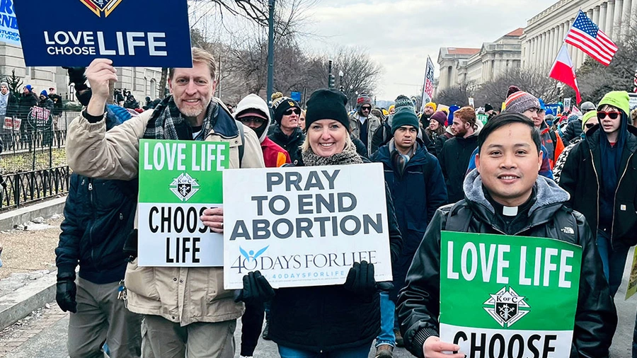 Brian Wilson (left), chancellor of Holy Family Council 10019 in Lewiston, Maine, and his wife, Ethna, march with seminarian Vinh Nguyen of the Diocese of Portland, Maine. Brian and Ethna first met during a 40 Days for Life prayer vigil.