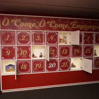 Photo of a museum gallery with Nativity scenes on exhibit. 