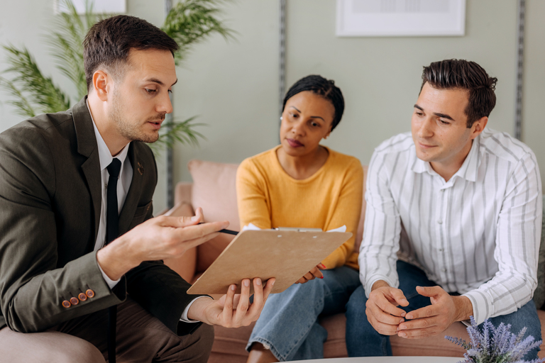 Insurance agent meeting with a couple in their home.