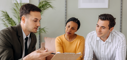 Insurance agent meeting with a couple in their home.