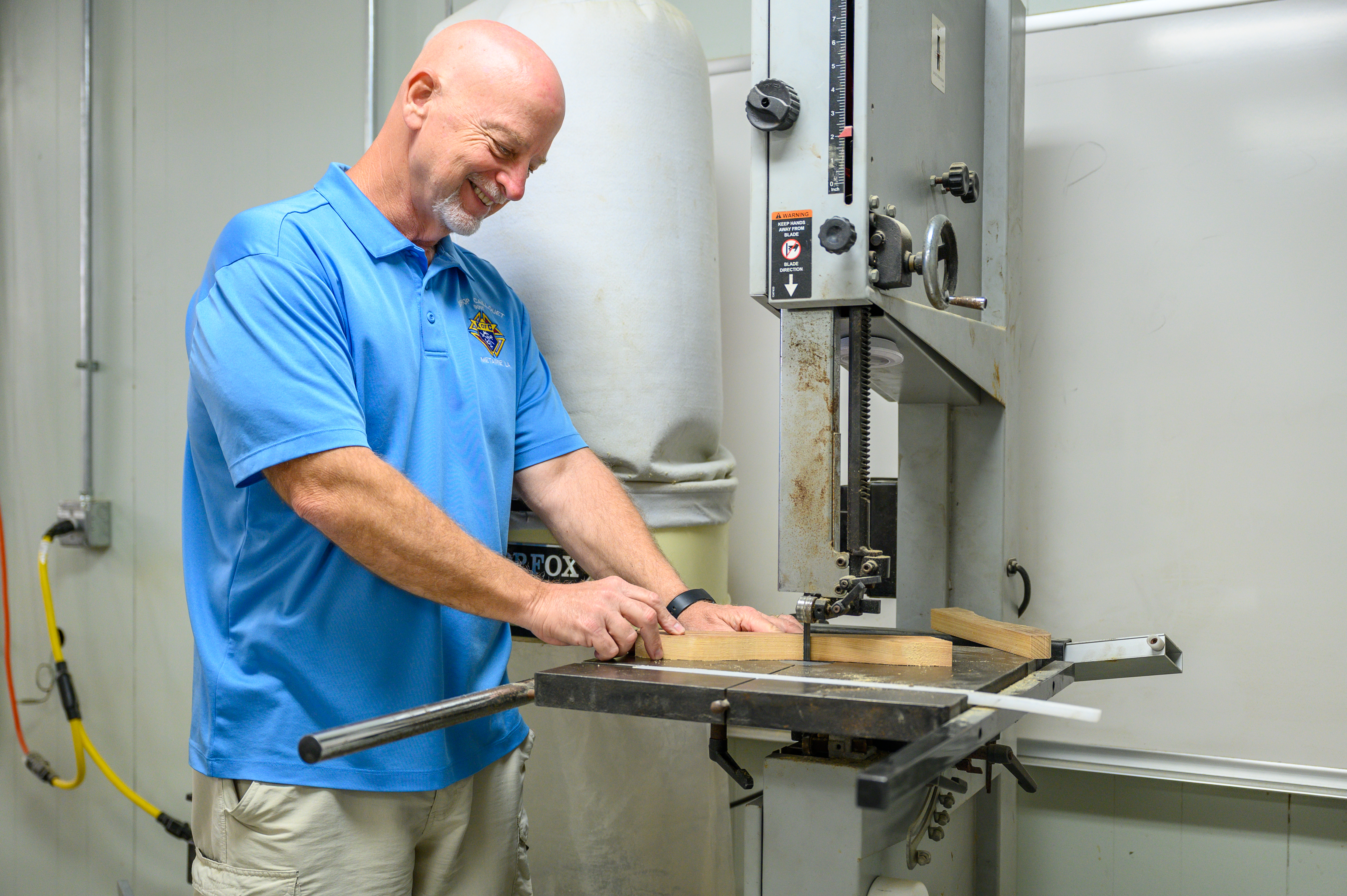 A Knight cuts wood during a workday with All God&rsquo;s Babies at the organization&rsquo;s workshop. 
