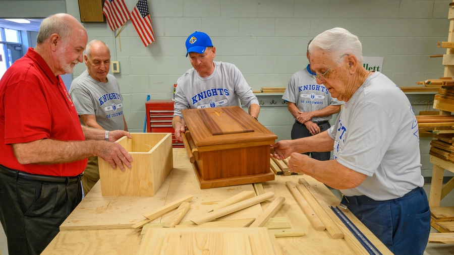 Knights from several councils across Louisiana construct caskets.