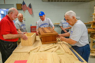 Knights from several councils across Louisiana construct caskets.