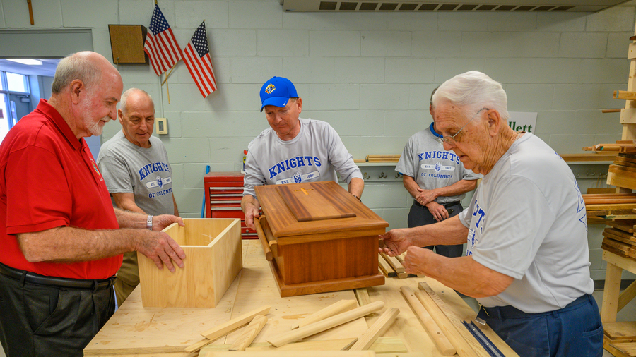 Knights from several councils across Louisiana construct caskets.