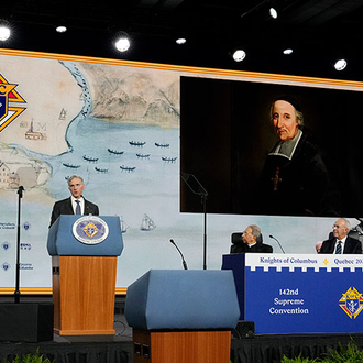 Images of St. François de Laval are shown as Supreme Knight Patrick Kelly delivers his annual report at the 142nd Supreme Convention on Aug. 6 in Québec City. The supreme knight described St. François, the first bishop of Québec, as an “outstanding model of missionary zeal and creative courage.”