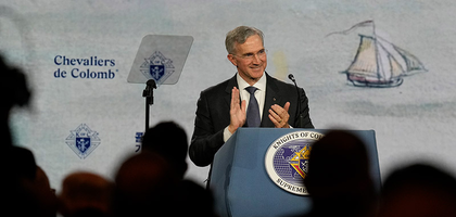 Supreme Knight Patrick Kelly leads applause during the Aug. 6 business session of the 142nd Supreme Convention in Québec City.