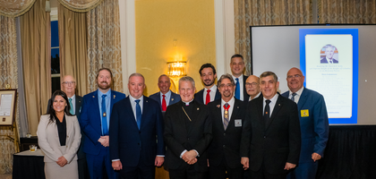 Archbishop Timothy Broglio of the Archdiocese for the Military Services, USA, is pictured with Supreme Director Jeffrey Crouch (fourth from left) and other representatives of the Knights and the Saint John XXIII Foundation in Charleston, S.C., on Oct 23. On behalf of the Order, Supreme Knight Patrick Kelly (pictured on screen at right) was recognized as honorary patron at the reception.