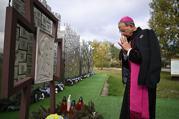Supreme Chaplain Archbishop William Lori prays Oct. 19 at a memorial to 119 victims of the 2022 Bucha massacre on the grounds of St. Andrew the First-Called Church in Bucha, Ukraine.