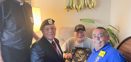 Members of Bishop Salpointe Council 4584 and St. Francis of Assisi Assembly 2058 in Sierra Vista, Ariz., present George Johnsen (seated) — a Knight of more than 70 years — with a plaque of St. Michael the Archangel to commemorate his 100th birthday. 
