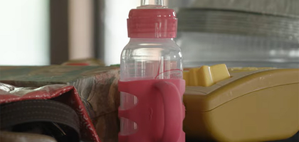 A baby bottle on a table.