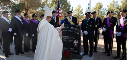 Members of several councils and assemblies in the Las Vegas area watch as Auxiliary Bishop Gregory Gordon of Las Vegas blesses a new memorial to Knights and clergy who served in the military.