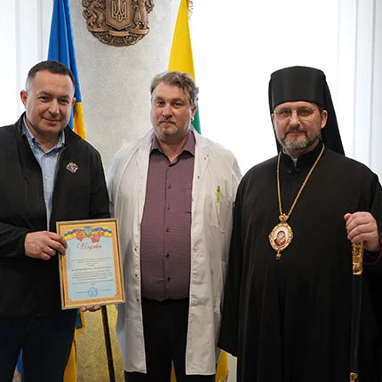 Bishop Mykhaylo Bubniy stands with State Deputy Youriy Maletskiy (left) and hospital chief Dr. Dmytro Fomin pose for photo.