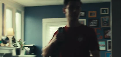 Still-shot from video of boy putting on backpack.