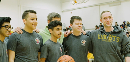 Knights of Columbus member with youth at basketball event