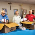Members of St. Philip the Apostle Council 17028 pack some of the 250 Boxes of Joy