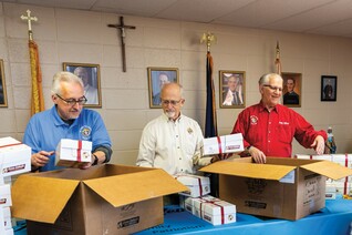 Members of St. Philip the Apostle Council 17028 pack some of the 250 Boxes of Joy