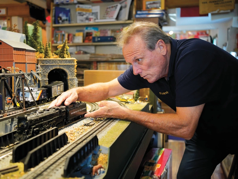 Frank Kotnik adjusts one of the K of C-themed engines used to pull the many festive boxcars