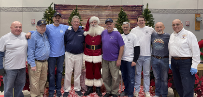 Knights from Prince of Peace Council 11537 in Hoover, Ala., stand with Santa (as depicted by a Prince of Peace parishioner) during the council’s annual Breakfast with Santa for families at Prince of Peace Catholic Church. 