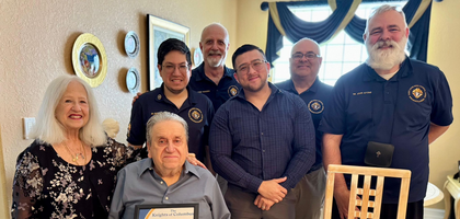Knights from St. John XXIII Council 14390 in Miramar, Fla., present Emiliano Montes (seated) with a certificate recognizing his service as a Knight during a recent visit to bring him holy Communion. The visit was part of the council’s new initiative to bring the Eucharist to homebound Knights and parishioners of St. John XXIII Parish.