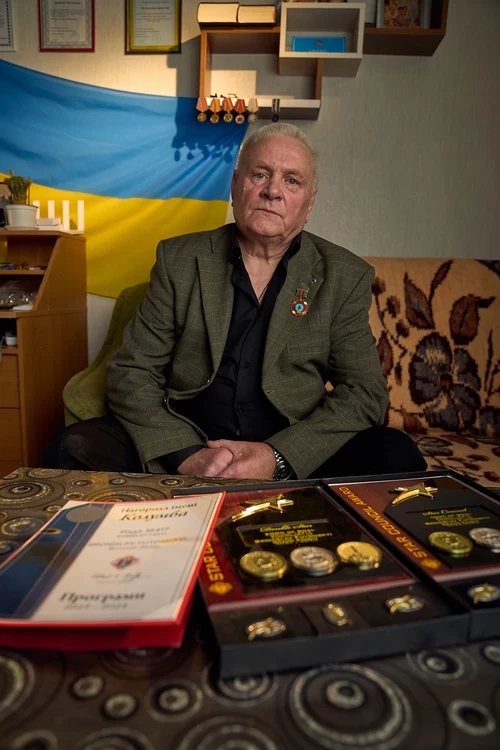 Bronislav Futomskyi, past grand knight of St. Charbel Council 16417, is pictured with Star Council and Double Star Council awards in his home.
