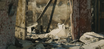 A building with an open doorframe in ruble and ruin