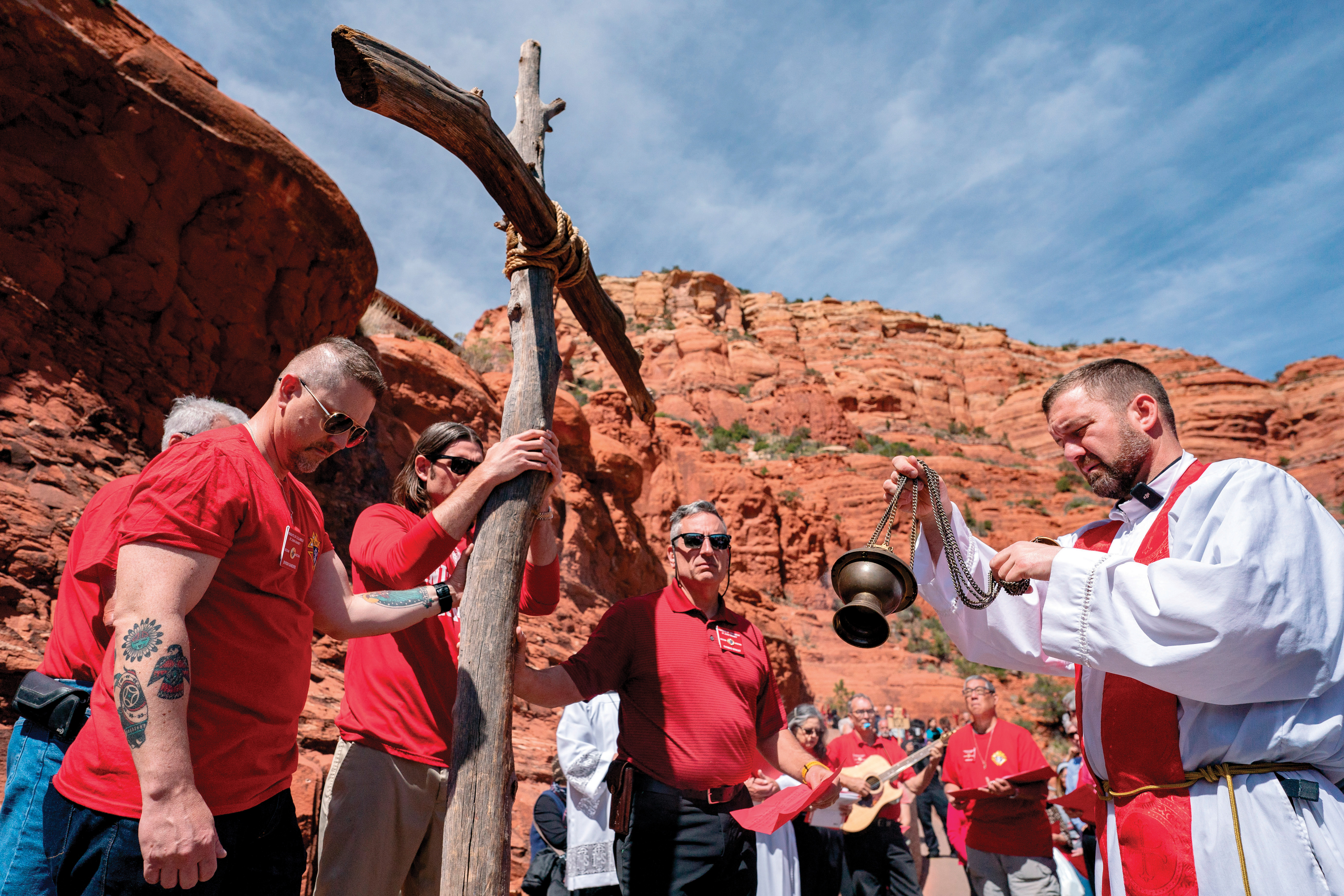 Arizona Knights hold a wooden cross as their chaplain leads the Stations of the Cross on Good Friday.