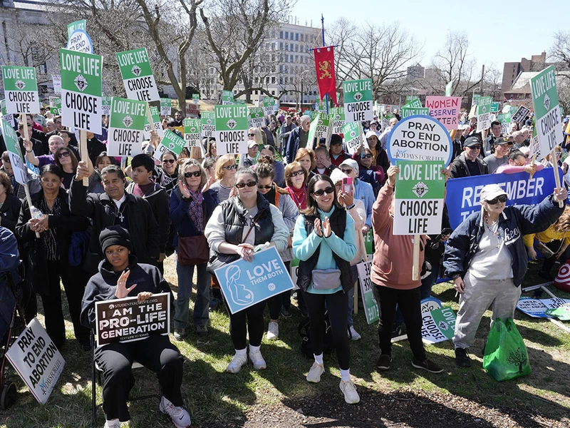 Pro-life demonstrators raise their  KofC &ldquo;Love Life, Choose Life&rdquo; signs high during a rally before the Connecticut March for Life in downtown Hartford on March 19.