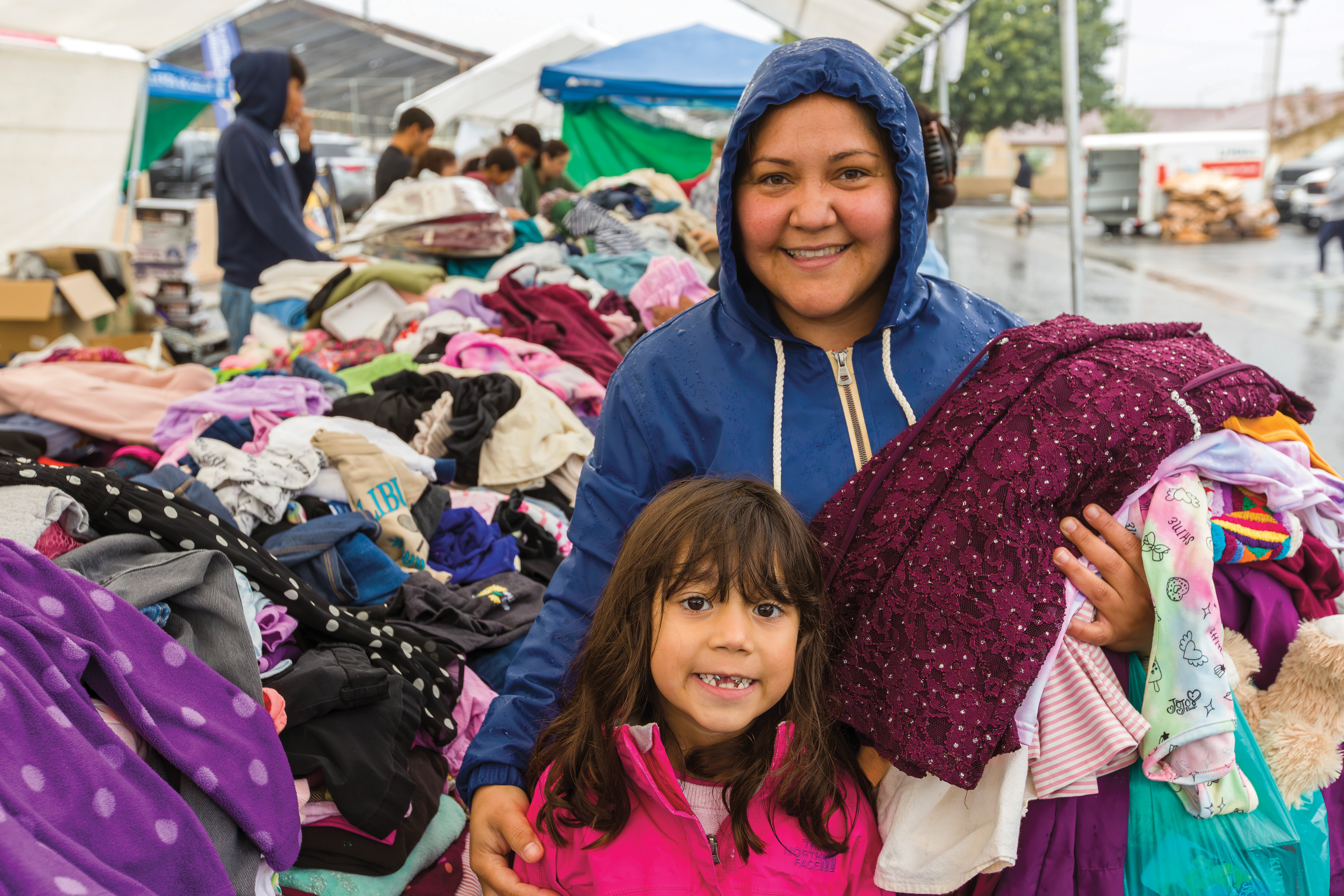A mother and daughter receive clothing during a Campesinos distribution in Hanford on Nov. 15, 2025.