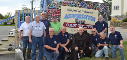 Knights from St. Thomas Aquinas Council 3023 in Derry, N.H., and Franciscan friars from St. Thomas Aquinas Parish gather in front of the council’s recycling collection trailer, parked across the street from the parish. Once the trailer is full — about once a month — Knights return the cans for cash at a local recycling center. Since June 2020, more than 29,000 pounds of aluminum have been recycled, raising over $12,400 for St. Jude Children’s Research Hospital.
