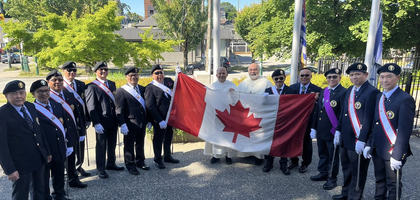Fourth Degree Knights from St. Pedro Calungsod Assembly 3400 in Vancouver, British Columbia, display the Canadian flag with Dominican Fathers Joseph D’Souza (left), pastor, and Gilles Simard, assistant pastor and faithful friar, before a flag-raising ceremony at St. Mary Parish to celebrate Canada Day. Father Simard offered a prayer at the ceremony, which was attended by more than 20 people.