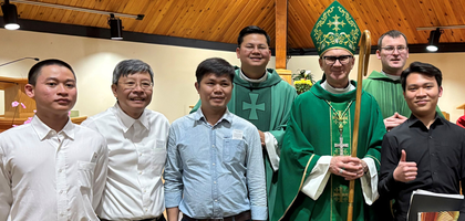 Bishop Joseph Dabrowski of Charlottetown gathers with men from the Vietnamese community at St. Francis of Assisi Church in Cornwall, Prince Edward Island, after a Mass and Vietnamese Lunar New Year celebration organized by St. Francis of Assisi Council 10808.