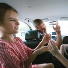 A family squabbles in a car.