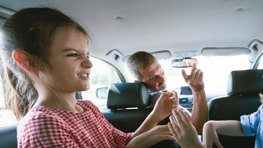 A family squabbles in a car.