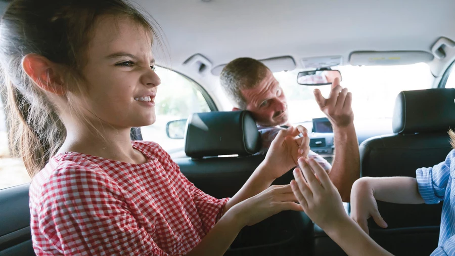 A family squabbles in a car.