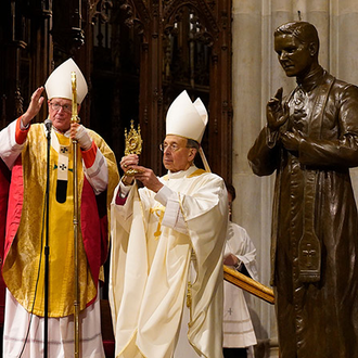 Cardinal Timothy Dolan, archbishop of New York, offers the closing blessing during Mass at St. Patrick’s Cathedral on Feb. 22, as Supreme Chaplain Archbishop William E. Lori of Baltimore.