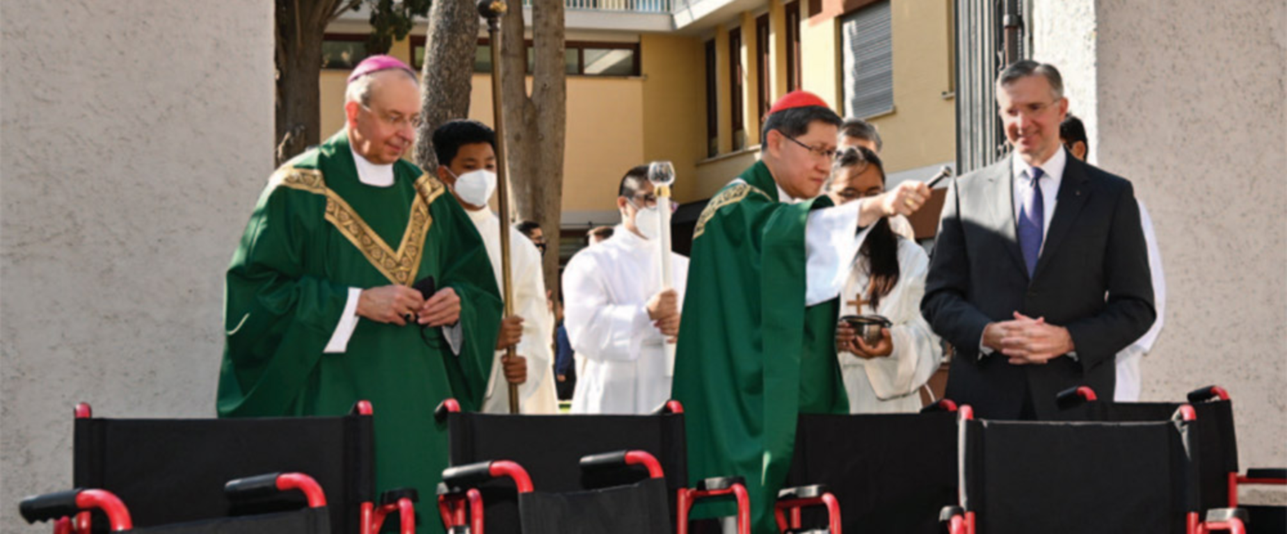 Cardinal Tagle, joined by Supreme Chaplain Archbishop William E. Lori and Supreme Knight Patrick Kelly in Rome, blesses wheelchairs donated by the Knights of Columbus for Afghan refugees.